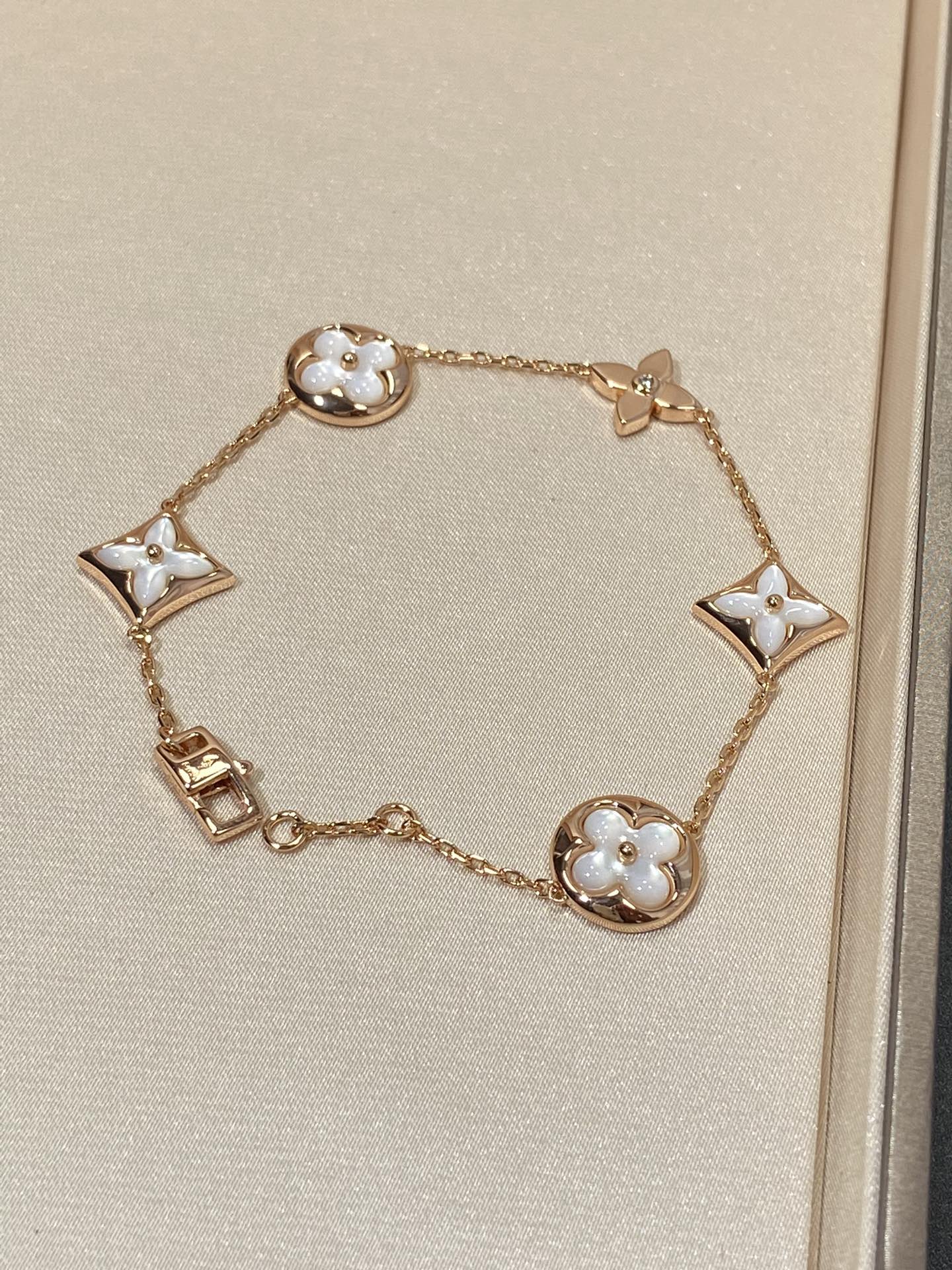 GlowSTAR AND SUN 5 MOTIF MOP PINK GOLD BRACELET